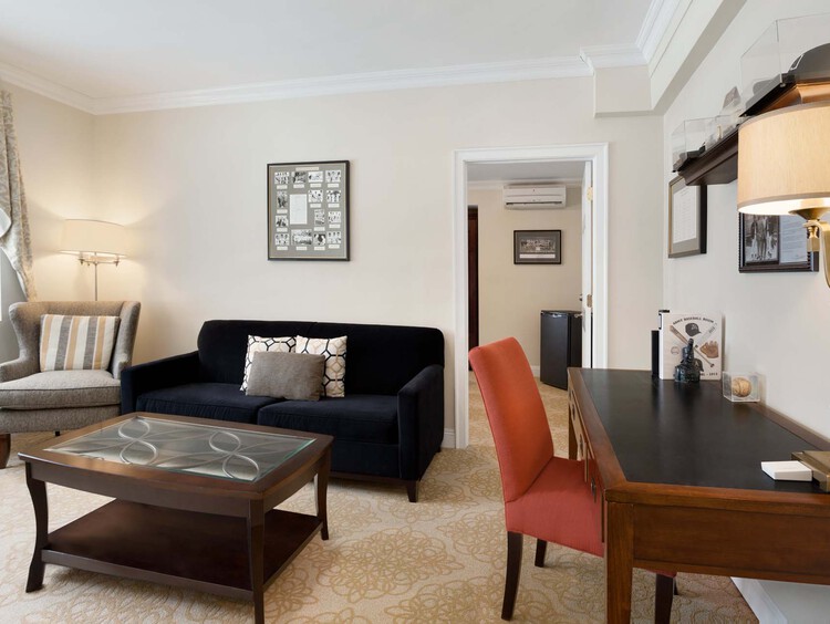 Executive Super Suite living space with desk and sofa